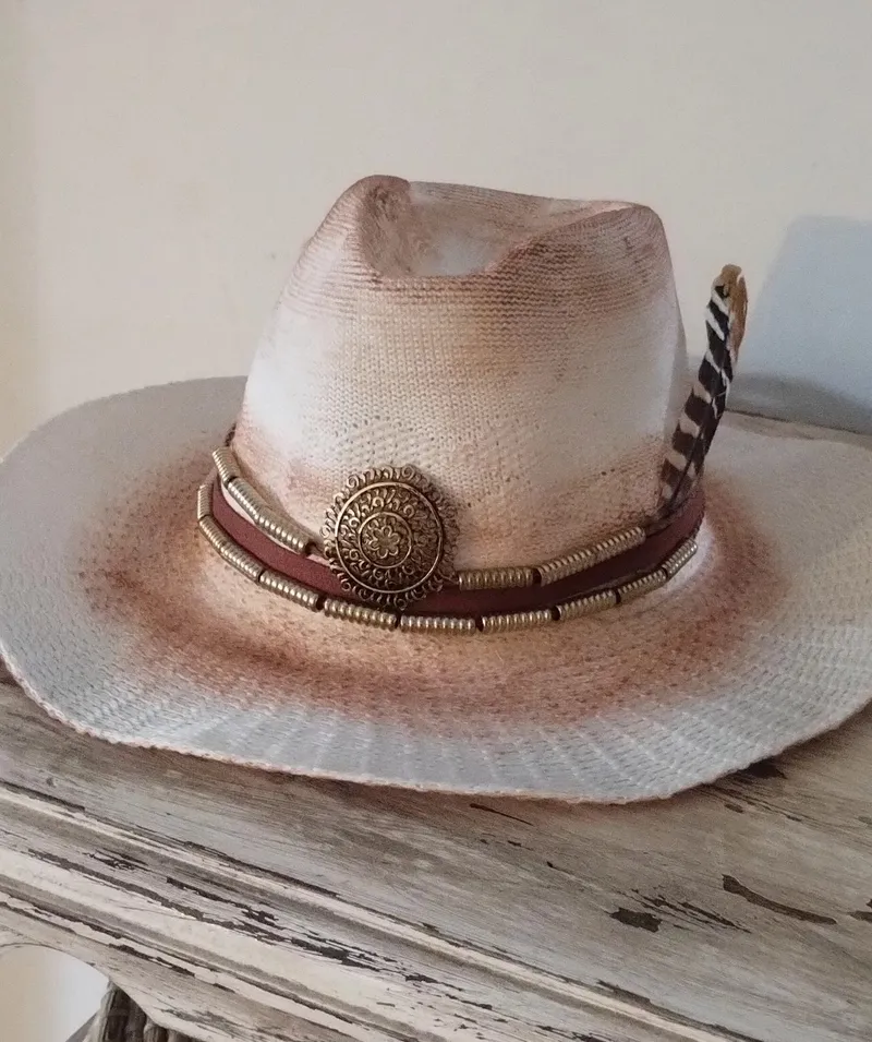 Sombrero blanco con degradé marrón, banda de cuero con concho metálico y pluma